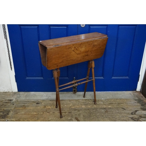 497 - A Late 19th Folding Mahogany Table resting on turned legs. Measuring: 69cms across x 86cms high. (Cl... 