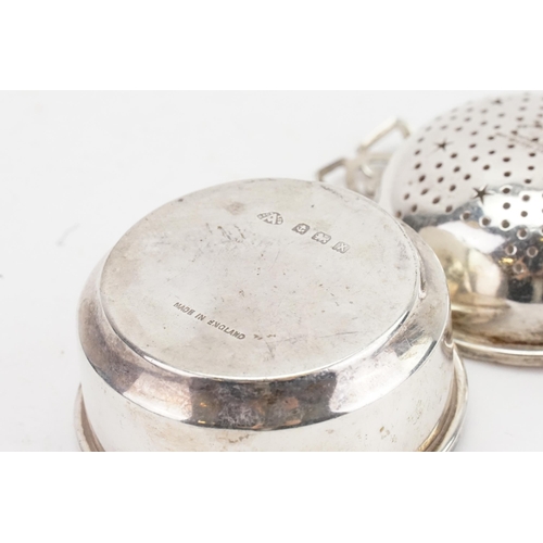 24 - A 1947 Adie Brothers silver tea strainer and stand. Weight 55g.