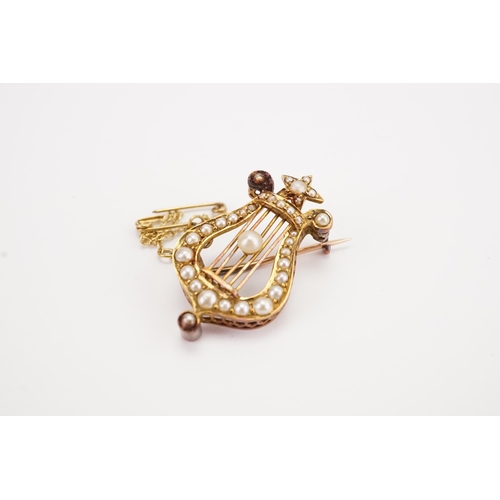 122 - A Victorian gold and seed pearl mounted Lyre Harp brooch, with safety chain. Weight 4.7g.