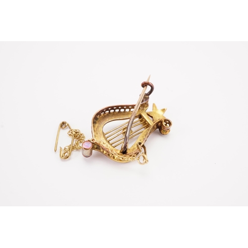 122 - A Victorian gold and seed pearl mounted Lyre Harp brooch, with safety chain. Weight 4.7g.