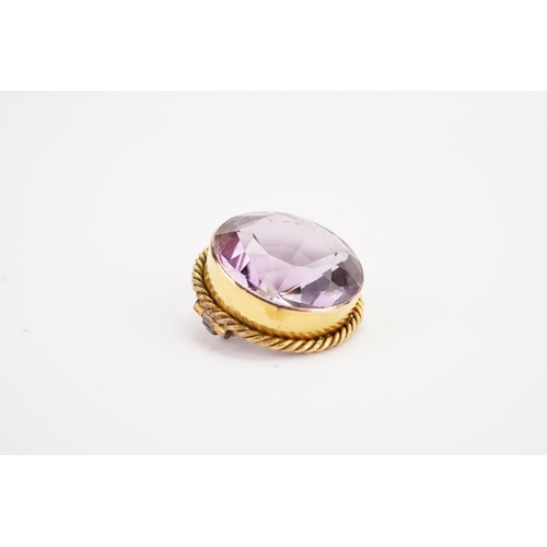 124 - A large amethyst brooch, set in a gold coloured mount. Weight 4.8g.