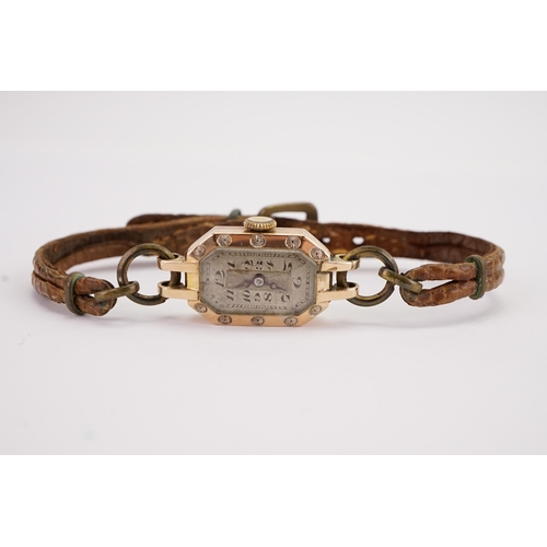 191 - A 9ct gold ladies cocktail watch with railroad dial, brown leather strap.