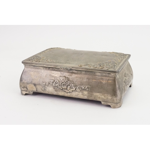 706 - A floral embossed pewter jewellery box, in the Liberty design, inlaid with purple.