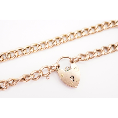 128 - A 9ct gold curb link love heart locket bracelet. All links marked. Weight 8.1g.