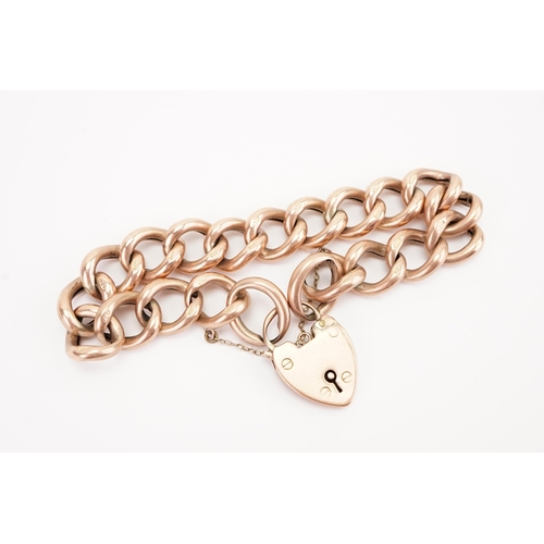 129 - A 9ct gold large curb link bracelet, with love heart locket.