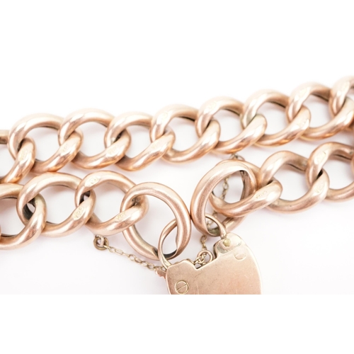 129 - A 9ct gold large curb link bracelet, with love heart locket.