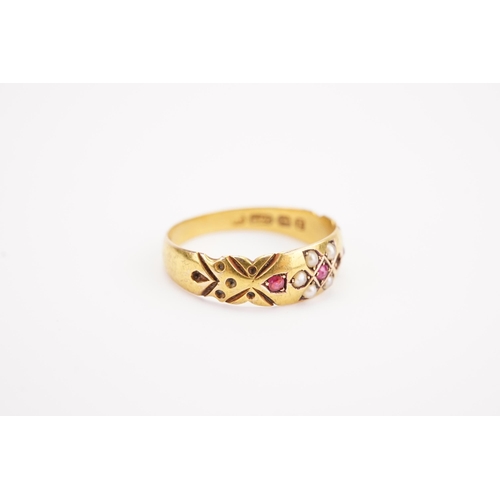 132 - A 15ct gold ruby and seed pearl set ring, in the Victorian design. Weight 2.2g. Size O.