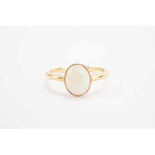 134 - A 18ct gold opal set ring, set with a single opal. Weight 2.4g. Size M.