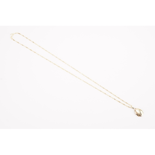 137 - A 9ct gold thin curb chain, hung with a 9ct gold locket. Weight 3.1g