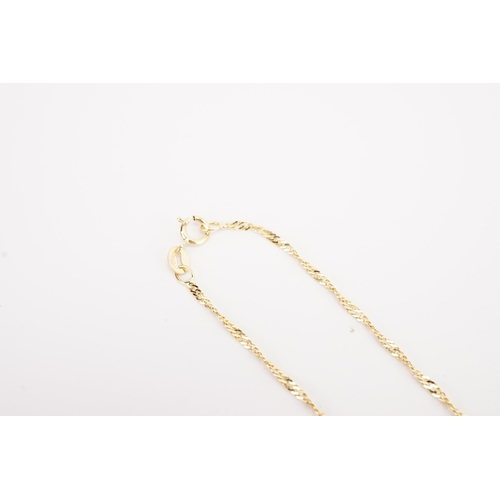 137 - A 9ct gold thin curb chain, hung with a 9ct gold locket. Weight 3.1g