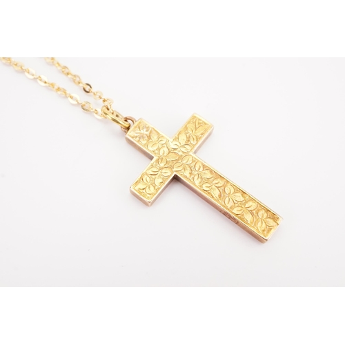 140 - A 9ct gold rolo chain, hung with a 15ct gold cross. Chain weight 2.5g. Cross weight 2.2g.