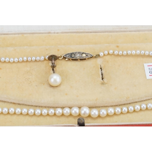 118 - A cased part set of pearls, with gold coloured clasps ad paste stones.