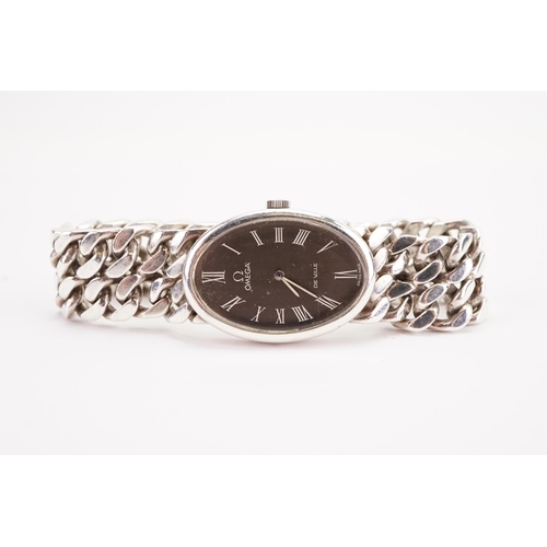 189 - A ladies Omega de Ville silver watch with oval dial on silver Omega curb bracelet. Silver weight inc... 