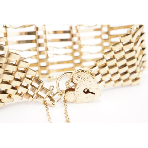 117 - A large 9ct gold gate link love heart padlock bracelet, safety chain. Weight 16g.