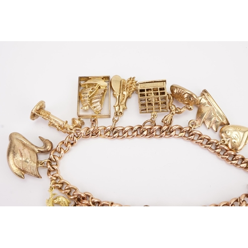 112 - A 9ct gold curb link charm bracelet, hung with various gold charms to include a 9ct gold Moet champa... 