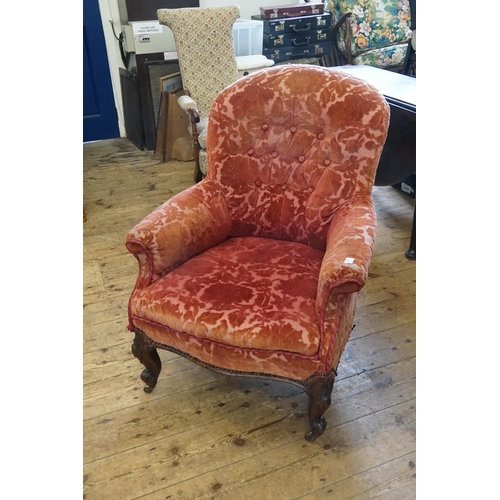 499 - A Victorian Mahogany Framed Easy Chair resting on Shaped Veloute Feet & upholstered in Red Floral Ve... 