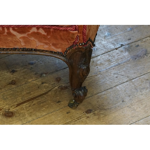 499 - A Victorian Mahogany Framed Easy Chair resting on Shaped Veloute Feet & upholstered in Red Floral Ve... 