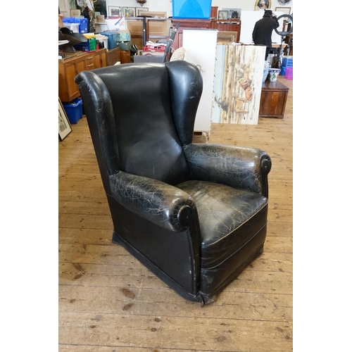 500 - A Leather Semi-Winged Fireside Chair with Roll Over Arms in Black.