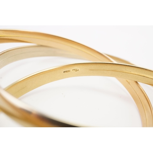 115 - A 18ct gold tri gold bangle. White, yellow and rose coloured. Only yellow gold bangle marked 750. We... 