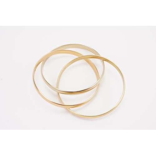 115 - A 18ct gold tri gold bangle. White, yellow and rose coloured. Only yellow gold bangle marked 750. We... 