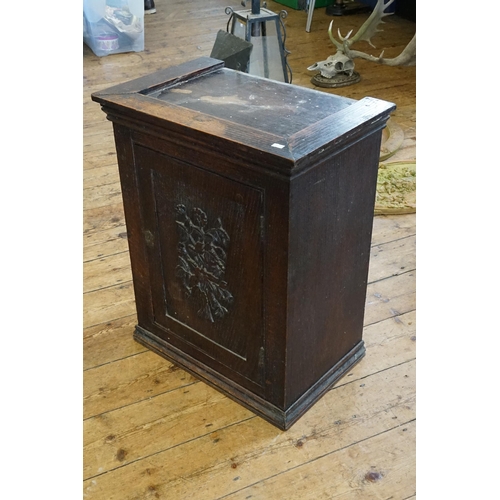 537 - An Oak Carved Panelled Fronted Single Door Cabinet. Measuring: 53cms x 34cms x 67cms high.