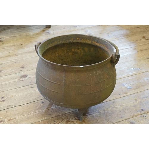 567 - A Cast Iron Witches Cauldron with Swing Handle.