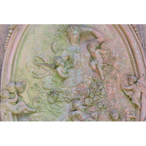 568 - A Classical Terracotta design Circular Garden Plaque decorated with a Classical scene & one other.