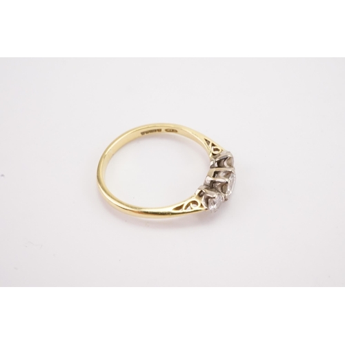 103 - A 18ct gold three stone diamond set ring, largest stone approximately 0.3ct. Weight 1.9g. Size L.