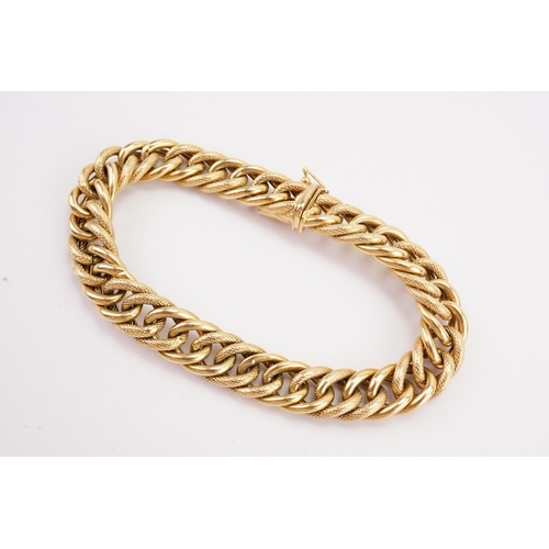 97 - A 18ct gold heavy curb link bracelet, with engraved design. Weight 21.8g. Length 20cm.