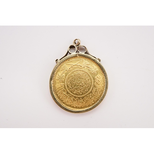 245 - A 1950's 22ct gold Arabic coin, in a 9ct gold mount. Total weight 9.1g.