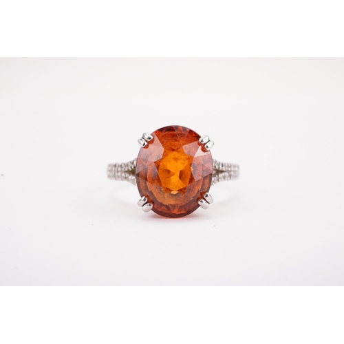 107 - A platinum mandarin garnet set ring, set with diamond shoulders. Approximately 0.5ct diamonds. A app... 