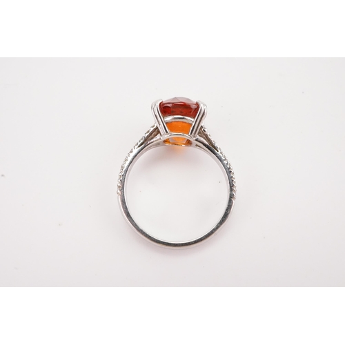 107 - A platinum mandarin garnet set ring, set with diamond shoulders. Approximately 0.5ct diamonds. A app... 