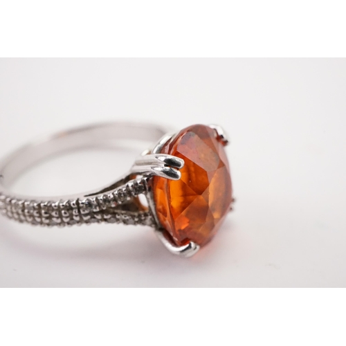 107 - A platinum mandarin garnet set ring, set with diamond shoulders. Approximately 0.5ct diamonds. A app... 