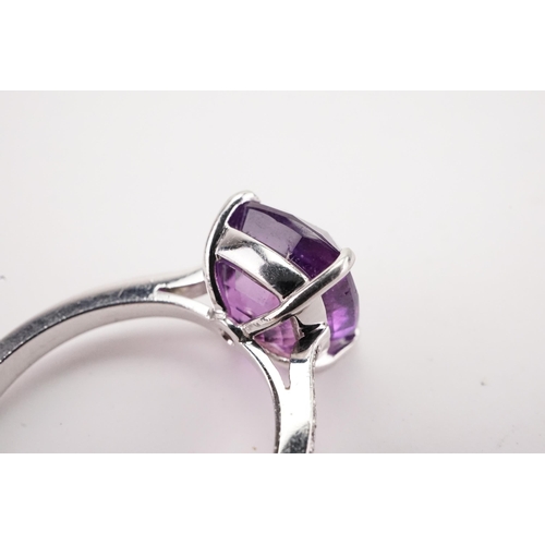 108 - A natural purple sapphire and diamond set ring, set with a East African translucent natural purple s... 