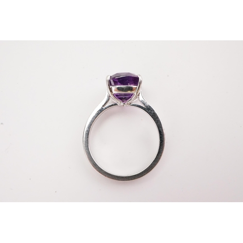 108 - A natural purple sapphire and diamond set ring, set with a East African translucent natural purple s... 