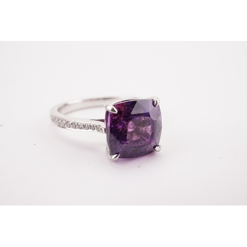 108 - A natural purple sapphire and diamond set ring, set with a East African translucent natural purple s... 