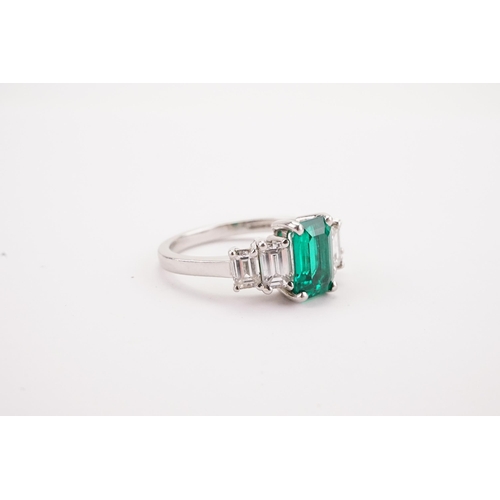 109 - A Columbium Natural Emerald and Diamond Set Ring, set with colourless rectangular diamond shoulders.... 