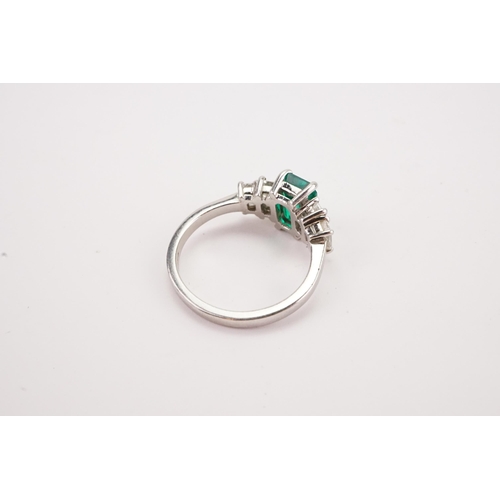 109 - A Columbium Natural Emerald and Diamond Set Ring, set with colourless rectangular diamond shoulders.... 