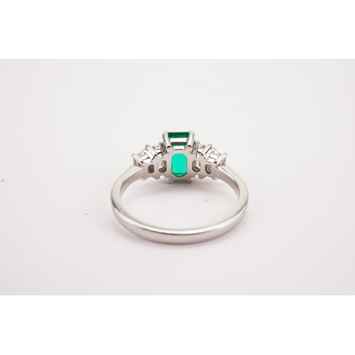 109 - A Columbium Natural Emerald and Diamond Set Ring, set with colourless rectangular diamond shoulders.... 