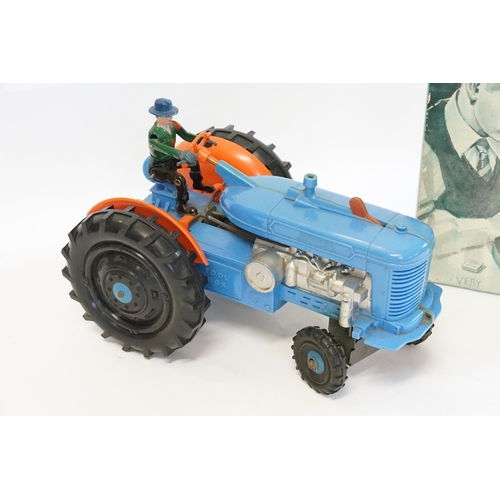 593 - A Large Plastic Battery Operated Tractor with Driver finished in Blue & Orange (Measuring: 27cms Lon... 