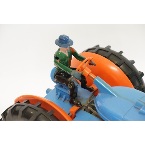 593 - A Large Plastic Battery Operated Tractor with Driver finished in Blue & Orange (Measuring: 27cms Lon... 