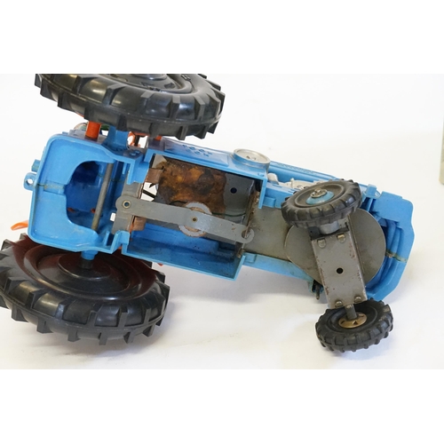 593 - A Large Plastic Battery Operated Tractor with Driver finished in Blue & Orange (Measuring: 27cms Lon... 