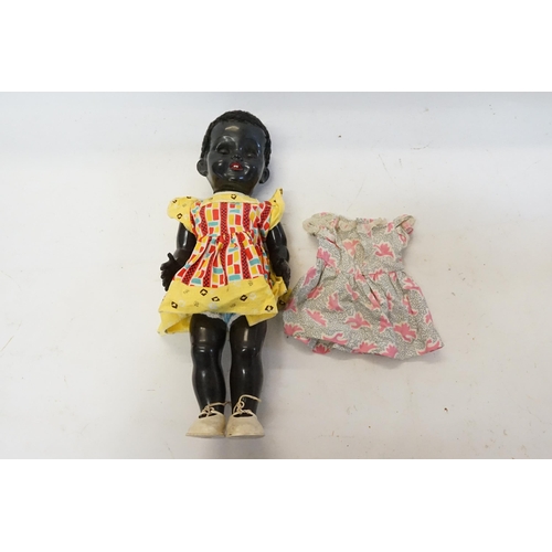 512 - A 1970s Pedigree Doll in a Dress with a Spare Dress. Measuring: 42cms.