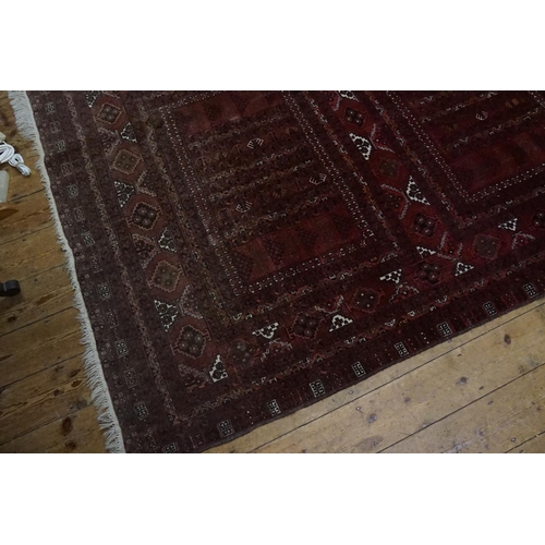 505 - A Red Ground Triple Diagonal Bordered Afghan Rug with a Gold pattern. Measuring: 2.45m x 1.70m.