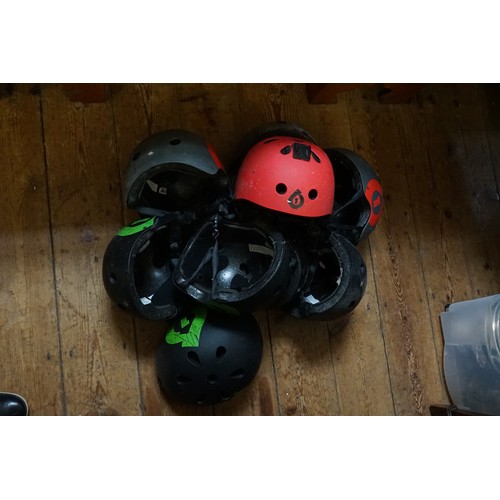 385 - A Collection of Nine Plastic helmets in Red, Grey & Black.