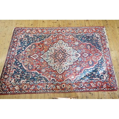 502 - An All Over Red Ground Blue Cornered Central Medallion Lozenge & Single Bordered Rug. Measuring: 310... 