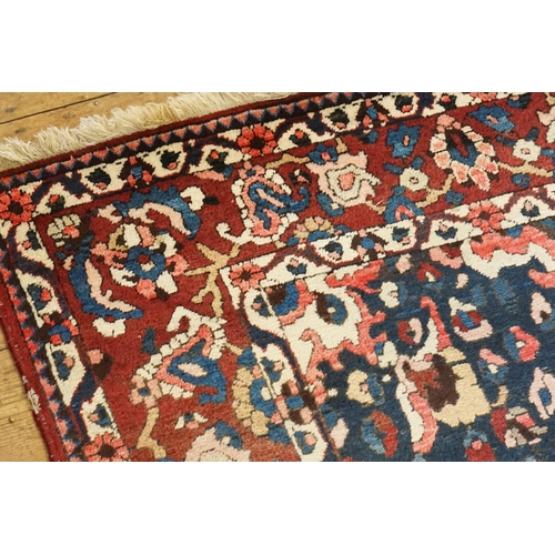 502 - An All Over Red Ground Blue Cornered Central Medallion Lozenge & Single Bordered Rug. Measuring: 310... 