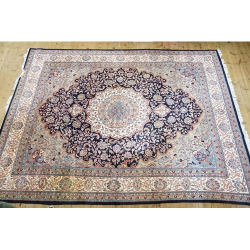 503 - A Dark Blue Ground Central Floral Medallion & Single Cream Bordered Carpet Rug with Fringe. Measurin... 