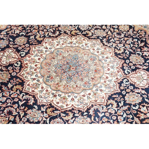 503 - A Dark Blue Ground Central Floral Medallion & Single Cream Bordered Carpet Rug with Fringe. Measurin... 