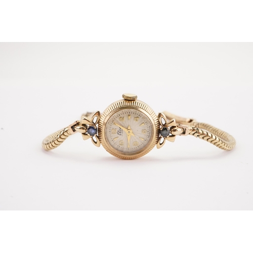 140 - A 9ct gold ladies Leco cocktail watch, set with two sapphires on the shoulders, 9ct gold snake brace... 